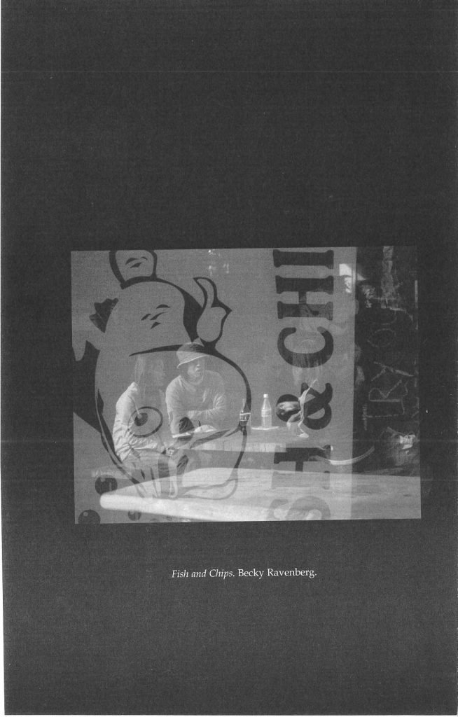 a reflection of some people eating on a window