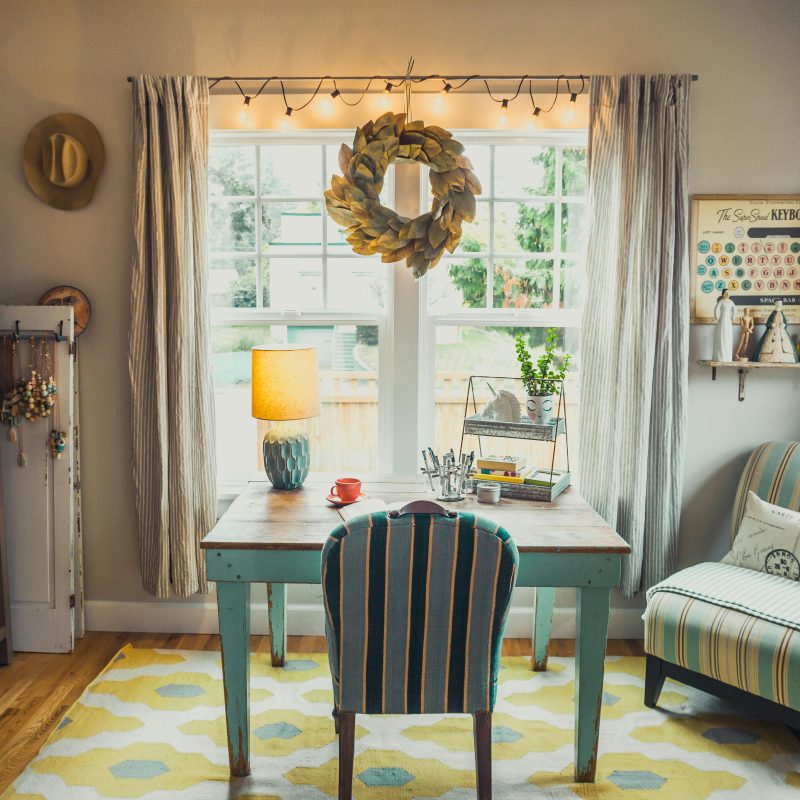 Writing workspace with teal furniture and natural light